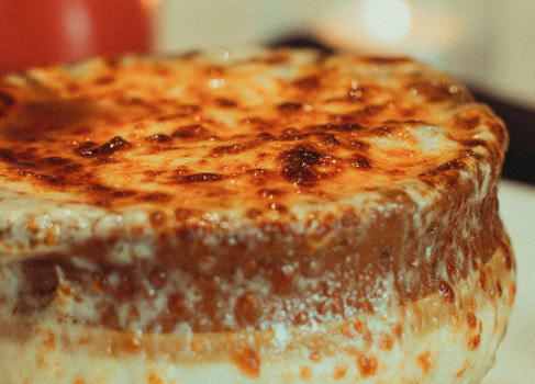 Delicious cheesy pizza with golden-brown crust from Olio.