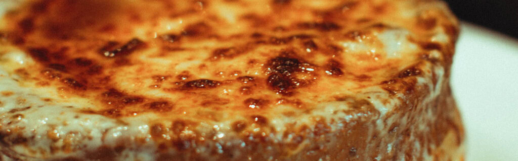 Close-up of a delicious, golden-brown baked dish from Olio.