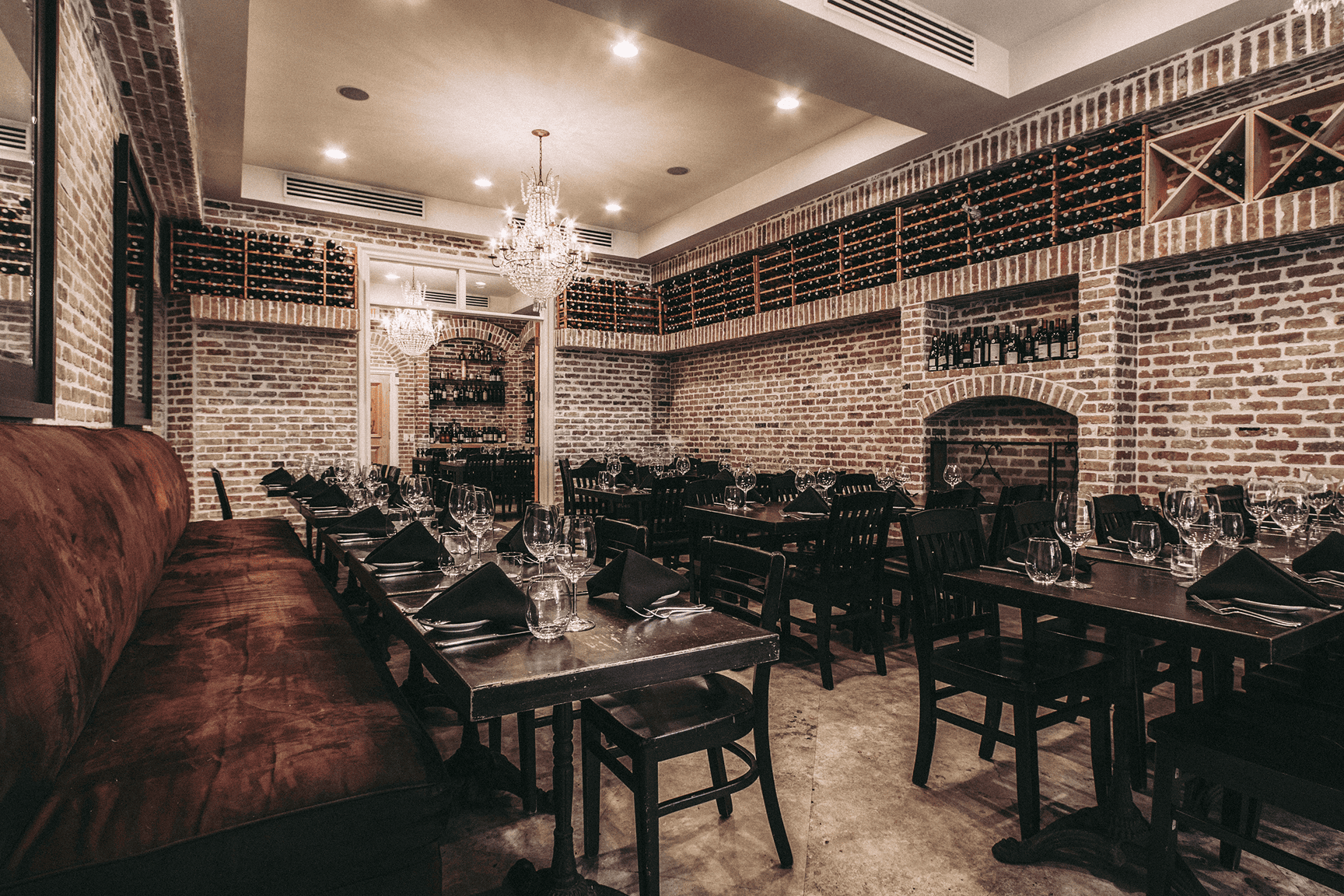 Elegant restaurant interior with brick walls and sophisticated decor.