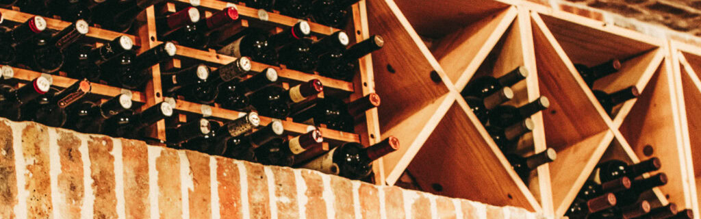 Elegant wine bottles stored in a wooden wine rack at Olio.